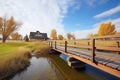 wooden bridge with brick supports over a prairie stream Royalty Free Stock Photo