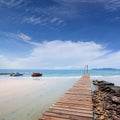 Wood bridge and corridor to the sea on Beautiful crystal clear sea and tropical beach at tropical paradise island, Thailand Royalty Free Stock Photo