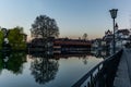 A wooden bridge crossing the river Aare  with the castle of Thun in the background early in the morning Royalty Free Stock Photo