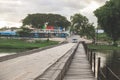 Wooden bridge crossing the river Macal with view on the city letters `San Iganacio` in Belize