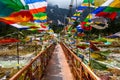 Wooden bridge decorated with colorful flags in Yume Samdong