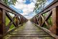 Wooden bridge in the forest with a sturdy railing. A walking area for pedestrians Royalty Free Stock Photo