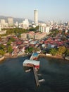 Wooden bridge at Georgetown heritage clan jetty. Background is KOMTAR tower. Royalty Free Stock Photo