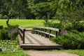 Wooden bridge in japanese garden thru the arc of branches Royalty Free Stock Photo