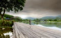 Wooden bridge at the lake in a sustainable hotel near the mountain. Luxury hotel in the forest. Green luxury hotel in the valley.