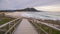 Wooden bridge leading to the Louro peak beach on a gloomy day in Galacia Spain