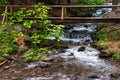 Wooden bridge over the brook Royalty Free Stock Photo