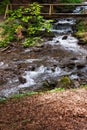 Wooden bridge over the brook Royalty Free Stock Photo