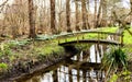 Wooden bridge over a canal in a park