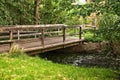 Wooden bridge over a creek as part of an old small weir near a historic watermill Royalty Free Stock Photo