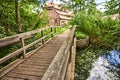 Wooden bridge over a creek as part of an old small weir near a historic watermill. Royalty Free Stock Photo