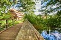 Wooden bridge over a creek as part of an old small weir near a historic watermill. Royalty Free Stock Photo