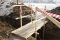 Wooden bridge over dug trench. Royalty Free Stock Photo