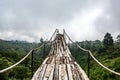 A wooden bridge over the jungle that breaks off at the end Royalty Free Stock Photo