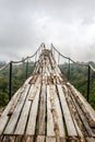 A wooden bridge over the jungle that breaks off at the end Royalty Free Stock Photo