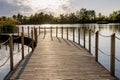 Long Wooden bridge over lake. Beautiful sunrise over lake pier. Planked footway on the river Royalty Free Stock Photo