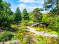 Wooden bridge over the lake in japaneese style garden. Botanical garden in Wroclaw, Poland Royalty Free Stock Photo