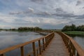 Wooden bridge over the lake of a natural park Royalty Free Stock Photo