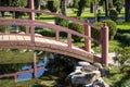A wooden bridge over a pond in a Japanese garden Royalty Free Stock Photo