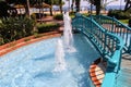 A wooden bridge over the pool with fountains in the park of the 100th anniversary of Ataturk Alanya, Turkey