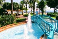 A wooden bridge over the pool with fountains in the park of the 100th anniversary of Ataturk Alanya, Turkey