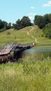 Wooden bridge over the river. River landscape. Path leading to the forest. Old footbridge over the reservoir. Connecting the banks Royalty Free Stock Photo