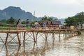 Wooden bridge over river song to riverside guesthouse. Royalty Free Stock Photo