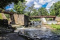 Wooden bridge over the river Vilia in Vilnius with a waterfall in the park Royalty Free Stock Photo