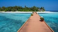 Wooden bridge over the sea leading to an island with sandy beaches and a green forest. Palm trees Royalty Free Stock Photo