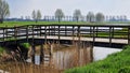 Wooden bridge over a small canal. Royalty Free Stock Photo