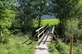 Wooden bridge over a small mountain river Royalty Free Stock Photo