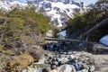 Wooden bridge over small river in the mountains Royalty Free Stock Photo