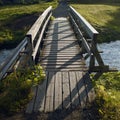 Wooden bridge over a small river Royalty Free Stock Photo