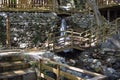 Wooden bridge over a small stream in the forest. Waterfall in the garden with rocks and leaves in autumn season. Royalty Free Stock Photo