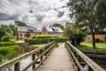 Wooden bridge over a small water canal in a beautiful park in the oldest city of Denmark, Ribe Royalty Free Stock Photo