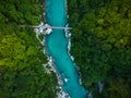 Wooden bridge over Soca river in Slovenia, top down drone image