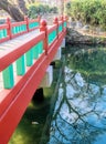 Wooden bridge over stream in public park Royalty Free Stock Photo