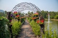 The wooden bridge park full of flowers Royalty Free Stock Photo