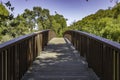 Wooden bridge in a park with green trees in the background. Clearlake, California Royalty Free Stock Photo