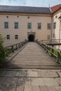 Wooden bridge with railing to the arch of the entrance to the castle. Transcarpathia Uzhhorod Ukraine Royalty Free Stock Photo