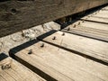 Wooden buildings. Detail with screws torn off the floorboards of an old wooden deck Royalty Free Stock Photo