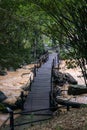 Wooden bridge on river. Small rustic wooden footbridge on small river stream in the forest. Royalty Free Stock Photo