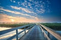 Wooden bridge through the river at sunrise