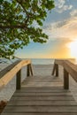 Wooden bridge on the sandy beach at sunset. Naples Beach, Florida Royalty Free Stock Photo