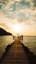 The wooden bridge on the sea in summer. The wooden bridge on sea at sunset, Thailand. Wooden bridge in the port over sea between Royalty Free Stock Photo