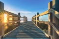 Wooden bridge spanning a sun-soaked sandy landscape