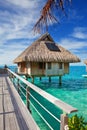 The wooden bridge to a hut over water at the ocean Royalty Free Stock Photo