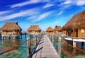 wooden bridge to a hut over water at the ocean Royalty Free Stock Photo