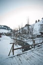 Wooden bridge in a traditional Romanian village across a small river. Bridge over frozen river. Winter landscape countryside Royalty Free Stock Photo