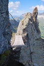 Wooden bridge on via ferrata Delle Trincee meaning Way of the trenches, Padon Ridge, Dolomites mountains, Italy